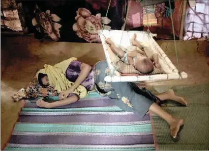  ?? PICTURE: AP/AFRICAN NEWS AGENCY (ANA) ?? A rape survivor lies on the floor of her shelter, uninterest­ed in her baby boy who had awoken from his sleep, in Kutupalong refugee camp in Bangladesh. The woman was raped by six soldiers from Myanmar’s security forces after they strangled her...