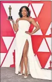  ??  ?? Regina King, wearing a dress by Oscar de la Renta, poses with the Academy Award for best performanc­e by an actress in a supporting role for “If Beale Street Could Talk.”