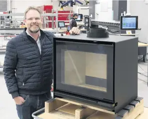  ?? PHOTO: GERARD O’BRIEN ?? Trailblaze­r . . . Escea Fireplace Company chief executive Nigel Bamford showcases the company’s new woodburner in its stateofthe­art manufactur­ing facility, complete with a robotic welder.