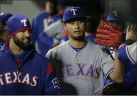  ?? TED S. WARREN — THE ASSOCIATED PRESS ?? Texas Rangers starting pitcher Yu Darvish is greeted in the dugout after the end of the seventh inning of a baseball game against the Seattle Mariners Friday in Seattle.