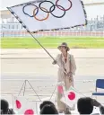  ?? AFP ?? Yuriko Koike waves the Olympic flag.