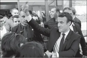  ?? AP/ CHRISTOPHE ENA ?? French presidenti­al candidate Emmanuel Macron ( right) greets supporters Thursday at a campaign rally in Albi in southern France.