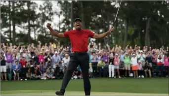  ?? DAVID J. PHILLIP — THE ASSOCIATED PRESS FILE ?? In this file photo, Tiger Woods reacts as he wins the Masters in April in Augusta, Ga. Fourteen years after his last Masters win and 11years after his last major, Woods claimed his fifth green jacket.