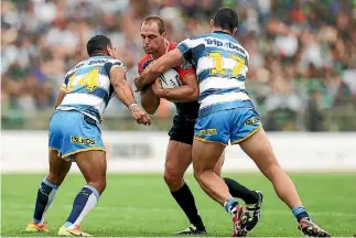  ??  ?? Simon Mannering charges into the Titans’ defence in their trial match at CET Arena in Palmerston North on Sunday.