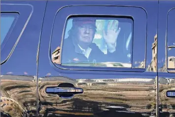  ?? Julio Cortez / Associated Press ?? President Donald Trump waves to supporters Saturday as his motorcade drives down Pennsylvan­ia Avenue as crowds of people gathered for a march in Washington.