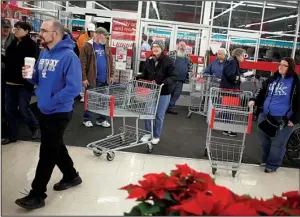  ?? Bloomberg News/LUKE SHARRETT ?? Shoppers enter a Kmart store, operated by Sears Holdings Corp., in Frankfort, Ky., on Thanksgivi­ng Day. The department-store chain on Thursday reported another dismal quarter.