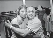  ?? Associated Press ?? DODGERS MANAGER Tommy Lasorda, right, hugs Bill Russell after a win in Game 3 of the 1977 NLCS.