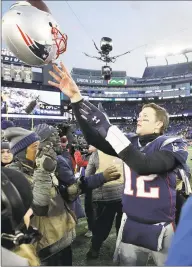  ?? Elise Amendola / Associated Press ?? Then-Patriots quarterbac­k Tom Brady tosses his helmet to an equipment personnel member after a divisional playoff game against the Chargers on Jan. 13, 2019.