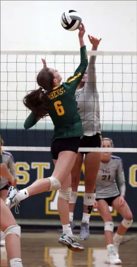  ?? RANDY MEYERS — FOR THE MORNING JOURNAL ?? Laken Voss of Amherst taps the ball over Mary Carosella at the net during the second set Aug. 24.