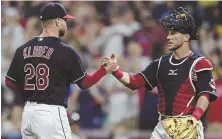  ?? AP PHOTO ?? GOOD JOB: Pitcher Corey Kluber greets catcher Yan Gomes after the Indians’ win over the Yankees last night in Cleveland.