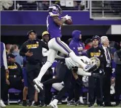  ?? Jeff Roberson The Associated Press ?? Vikings wide receiver Stefon Diggs, top, makes a catch Sunday over New Orleans Saints free safety Marcus Williams in Minneapoli­s.