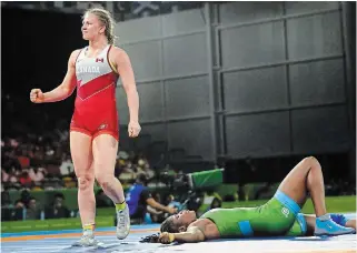  ?? MANISH SWARUP THE CANADIAN PRESS FILE PHOTO ?? Canada’s Erica Wiebe, left, celebrates after beating Nigeria’s Blessing Onyebuchi to take gold in women’s freestyle 76-kilogram wrestling at the Commonweal­th Games in 2018.