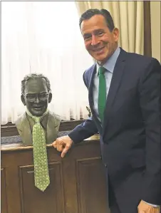  ?? Jacqueline Smith / Hearst Connecticu­t Media ?? Outgoing Gov. Dannel P. Malloy jokingly puts his glasses on a bust in his outer office to prove that it is really him.