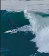  ?? JIM SEIMAS – SANTA CRUZ SENTINEL ?? Surfers stayed in the water after sunset Thursday at Steamer Lane, where epic sets continued to rolling in.