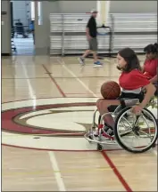  ?? PHOTOS BY JUSTIN COUCHOT — ENTERPRISE-RECORD ?? Ability First sports camper Ashlyn Smith moves with the ball down the court during a basketball scrimmage on the second day of the Ability First sports camp on Friday, at Chico High School in Chico.