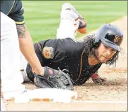  ?? NORM HALL / GETTY IMAGES ?? The Giants’ Brandon Crawford is picked off first base by A’s pitcher Kendall Graveman in the second inning Friday in Mesa, Ariz. Oakland won 6-1.