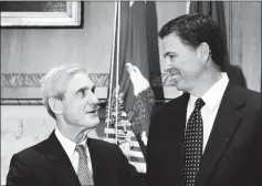  ?? ASSOCIATED PRESS ?? IN THIS SEPT. 4, 2013, FILE PHOTO, then-incoming FBI Director James Comey talks with outgoing FBI Director Robert Mueller before Comey was officially sworn in at the Justice Department in Washington. The Justice Department said Wednesday that it is...