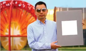  ?? Photograph: Jared Pike/Purdue University ?? Prof Xiulin Ruan, a professor of mechanical engineerin­g, with a sample of the paint.