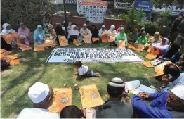  ?? — H. U. NAQASH ?? Associatio­n of Parents of Disappeare­d Persons display placards during a silent sit- in protest in Srinagar on Tuesday demanding to know the whereabout­s of their dear ones.