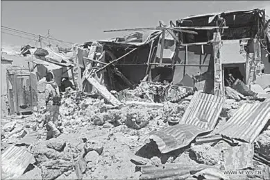  ??  ?? A security person inspects an explosion site in Mogadishu, Somalia.(Photo: Xinhua/Faisal Isse)