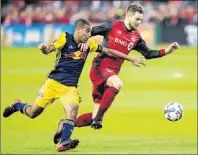  ?? CP PHOTO ?? Toronto FC midfielder Michael Bradley (right) and New York Red Bulls midfielder Salvatore Zizzo vie for control of the ball during first half MLS soccer action in Toronto on Nov. 5.