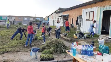  ??  ?? WORKERS clean up outside the Bonteheuwe­l Multiplepu­rpose Centre which has become a community care centre for Covid-19 patients.