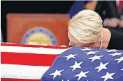  ?? [AP PHOTO] ?? Cindy McCain, wife of John McCain, lays her head on the casket during a memorial service Wednesday at the Arizona Capitol in Phoenix.
