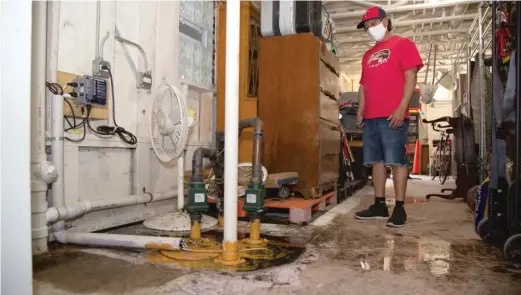  ?? ANTHONY VAZQUEZ/SUN-TIMES ?? Mauricio Vasquez stands next to a pump where sewage water leaks into in his basement in a CHA property in Heart of Chicago.