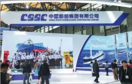  ?? ?? People gather at the booth of China State Shipbuildi­ng Corp during the recent Marintec China expo in Shanghai.