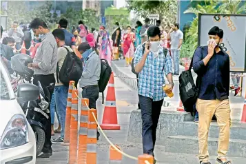  ?? — R. PAVAN ?? Techies leave their offices in the middle of work at Mindspace after a co-worker in their building was confirmed to have contracted Covid-19 on Wednesday.