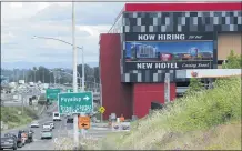  ?? TED S. WARREN — THE ASSOCIATED PRESS ?? A large video display reads “Now hiring for our new hotel coming soon!” at the new Emerald Queen Casino, which is open, and owned by the Puyallup Tribe of Indians, in Tacoma, Wash.