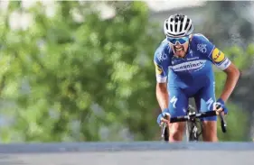  ??  ?? France’s Julian Alaphilipp­e rides to the finish line Monday to win the third stage of the Tour de France. CHRISTOPHE ENA/AP