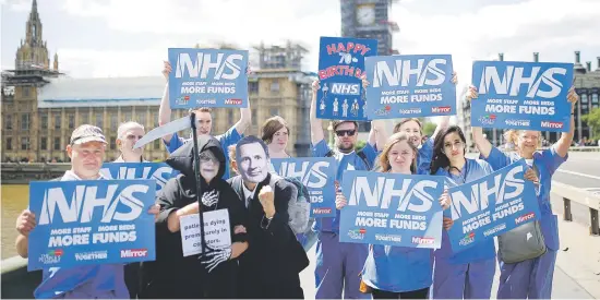  ?? Pictures: Reuters ?? WE WANT MORE. National Health Service staff hold banners and placards during a posed protest in central London, UK, last week.