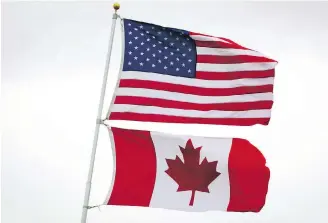  ?? DARRYL DICK, THE CANADIAN PRESS ?? U.S. and Canadian flags fly in Point Roberts, Washington. The first Canadian customs sites in the United States could be coming to Arizona and Florida as trials.