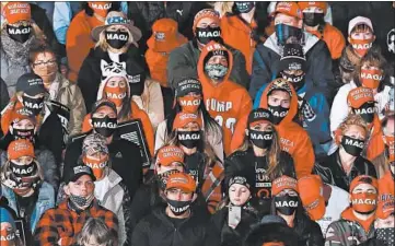  ?? CHRIS SWEDA/CHICAGO TRIBUNE ?? Supporters of President Donald Trump listen during a rally Oct. 17 at Southern Wisconsin Regional Airport in Janesville.