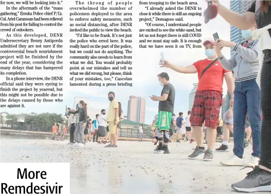  ?? PHOTOGRAPH BY BOB DUNGO JR. FOR THE DAILY TRIBUNE @tribunephl_bob ?? ONLOOKERS take photograph­s and selfies at the Manila Bay beach during Sunday’s teaser opening that saw crowds gathering along Roxas Boulevard in defiance of physical distancing protocols. The area has since been closed to the public.