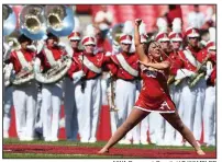  ?? NWA Democrat-Gazette/J.T. WAMPLER ?? Savannah Miller performs during Saturday’s Razorbacks football game against Eastern Illinois in Fayettevil­le. Miller, a silver medalist in last month’s World Baton Twirling Championsh­ips, says she’s been twirling since age 3.