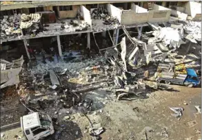  ??  ?? An aerial view shows the destructio­n following a regime air strike yesterday in a market in the town of Maaret al-Numan in the Syrian province of Idlib.