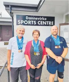  ?? ?? Eddie and Lorraine Warrington with Glen Hurst — all from Dannevirke — display their medal haul from the NZ Masters Games held in Dunedin in February.