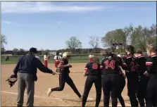  ??  ?? Hatboro-Horsham’s Amya Lundy approaches home plate as her teammates prepare to celebrate her home run against Souderton.