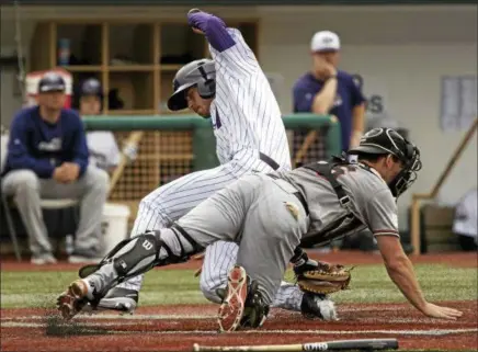  ?? JEN FORBUS — THE MORNING JOURNAL ?? The Crushers’ Kevin Lachance scores ahead as Schaumburg catcher James Keller tries for a tag on June 10 at Sprenger Stadium.