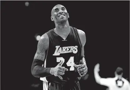  ?? Associated Press ?? Los Angeles Lakers’ Kobe Bryant smiles as he jogs to the bench during the first half against the Philadelph­ia 76ers on Dec. 1 in Philadelph­ia.