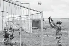  ?? Capt. Mikel Arcovitch / Associated Press ?? Army Pfc. Rafiou Affoh, a carpentry and masonry specialist, plays volleyball with Afghan evacuees at Camp Liya.