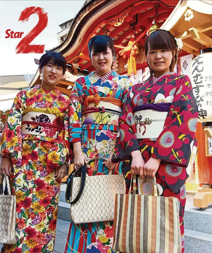  ?? — YUEN MEIKENG/The Star ?? Girls dressed in kimonos taking a stroll along the Jishu-jinja shrine, located within the grounds of the Kiyomizu Temple in Kyoto, Japan.