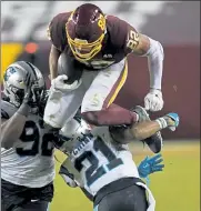  ?? CAROLYN KASTER / AP ?? Washington Football Team tight end Logan Thomas leaps over Carolina Panthers‘ Jeremy Chinn (21) for a first down last week.