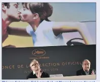  ??  ?? Thierry Frémaux (ici à gauche), et Pierre Lescure devant l’affiche du e Festival de Cannes, lors de la présentati­on de la sélection officielle. (Photo AFP)