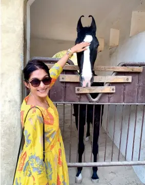  ??  ?? FROM MY TRAVELS
I am an animal lover.
I met Alisha (the horse in the pic) at Mihir Garh, Jodhpur. She is one of the 10 horses at the property’s stable; all of them are below the age of four. I fed her some jaggery, and it was love at first sight!