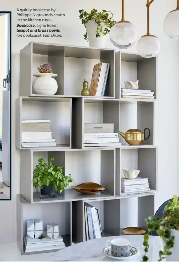  ??  ?? A quirky bookcase by Philippe Nigro adds charm in the kitchen nook.
Bookcase, Ligne Roset;
teapot and brass bowls (on bookcase), Tom Dixon.