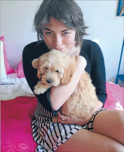  ??  ?? Puppy love: Paremata girl Harriet Rowland has had posthumous success with her book The Book of Hat, about her battle with cancer. She is pictured with her dog Kelly before she died in March this year.