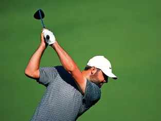  ?? MATT SLOCUM/THE ASSOCIATED PRESS ?? Scottie Scheffler hits on the practice range Monday during a practice round in preparatio­n for the Masters at Augusta National Golf Club in Augusta, Ga.